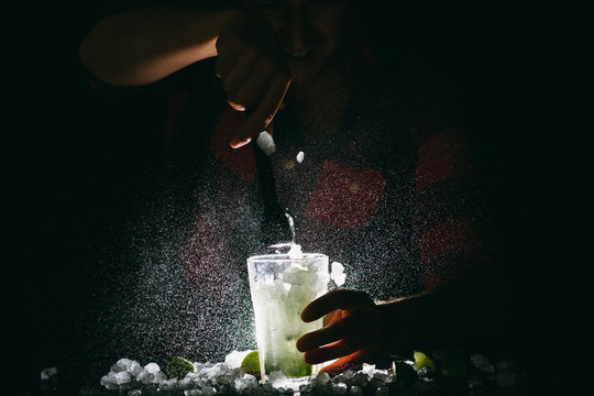 Barman making Mojito and spalshing it out