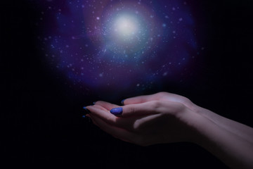 Magic light in palm, stardust and magic in your hands, stars and space