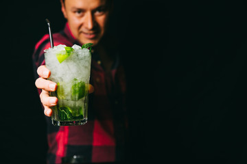 Close-up of Mojito in barman's hand 