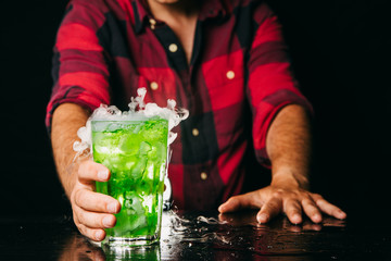 Barman serving magic green cocktail