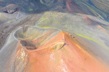 Old extinct inactive craters on the slope of the volcano Etna with tourist trails, aerial top view.