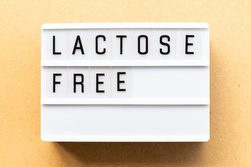 Light box with word  lactose free on wood background