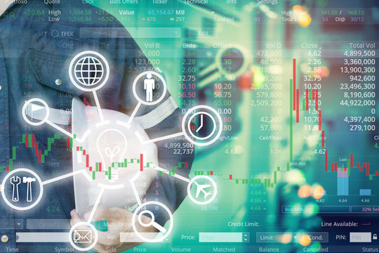 Double exposure of  business man or Engineer holding helmet with industry control room and stock trading chart background for investment business concept