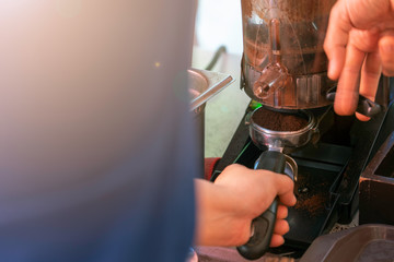 Barista are holding Cup of fresh coffee powder.