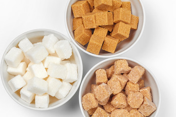 White refined sugar and brown unrefined sugar cubes