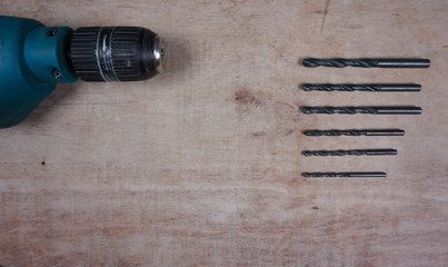 Close up electric drill set, screwdriver set, adapter on wooden background with copy space for your own text