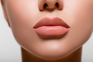 Beautiful lips macro. Beauty. mouth. makeup. Closeup Model Peach Color in Studio. - image.  - obrazy, fototapety, plakaty