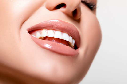 Beauty. perfect white teeth. smile. Closeup Model lips beige in Studio. - image 