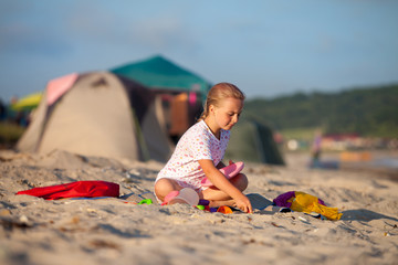 Little girl playing at sandy beach