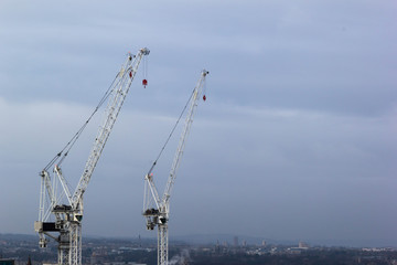 White tower cranes with blue sky