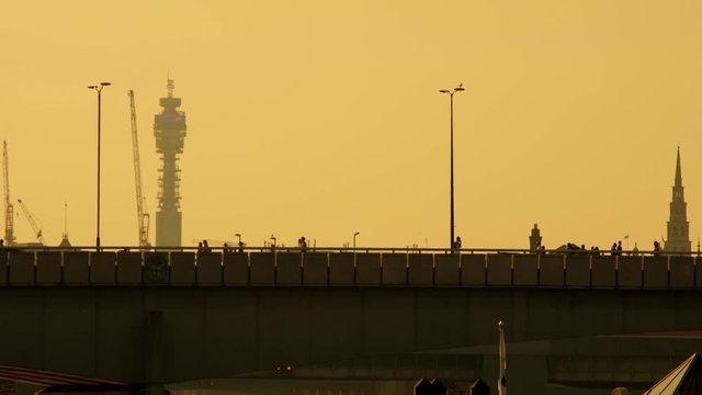 Sunset silhouette of London Bridge and the BT Tower. 