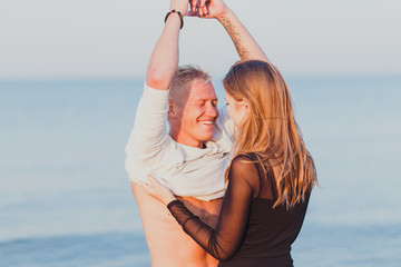 a couple in love a man and a girl meet the dawn in bed on the beach