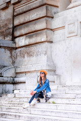 A beautiful woman sitting on the stairs