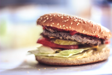 Delicious fresh homemade burger on a wooden table