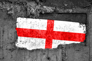 The flag of England on a dirty wooden surface, built into a concrete base, with scuffs and...