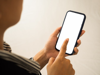 Closeup of female hands pointing finger blank screen smart phone.