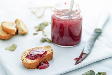 Quick light Breakfast with cookies and strawberry jam, healthy morning snack with baked cantuccini and confiture