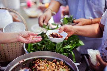 Helping People With Hunger With Kindness : the concept of life problems, hunger in society : concept of charity food for the poor : Hand-feeding to the needy in society