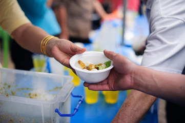 donating food is helping human friends in society : Helping People With Hunger With Kindness : the concept of life problems, hunger in society : Hand-feeding to the needy in society