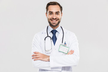 Portrait of brunette young medical doctor with stethoscope smiling at camera and standing wth arms crossed - Powered by Adobe