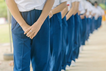 Group of students try to meditate for the peace of mind by walk with Buddhist monk in school.