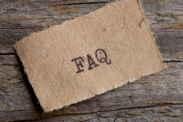 FAQ word on a piece of paper close up, business creative motivation concept