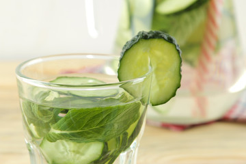 water with cucumber. Refreshing diet water with cucumber and mint in a glass beaker against a blue background. detox drink concept. summer refreshing drink. top view