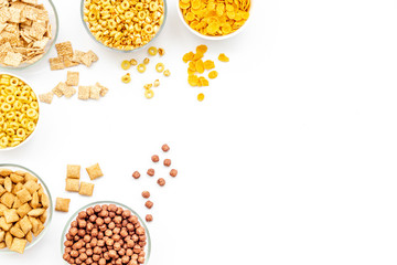 cereals, oatflakes and cornflakes for healthy breakfast on white background top view mock up