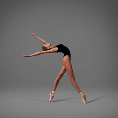 Ballerina makes a back arch. Color photo.