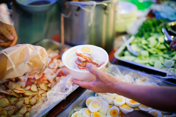 Hand begging for food from the rich's share : The beggar is waiting for food from charity aid : the concept of begging and hunger : Hunger problems of the poor have been donated food to reduce hunger
