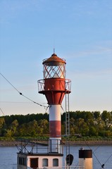 Fototapeta na wymiar old lighthouse on top of a boat