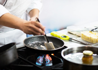 Chef preparing food in the kitchen, chef cooking, closeup