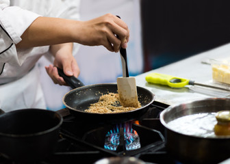 Chef preparing food in the kitchen, chef cooking, closeup
