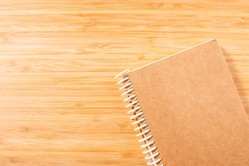 Notebook on brown wooden table.