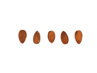 five almond seeds isolated on white background