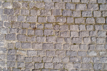 Top view of old cobblestone pavement. Street with granite cobblestoned pavement