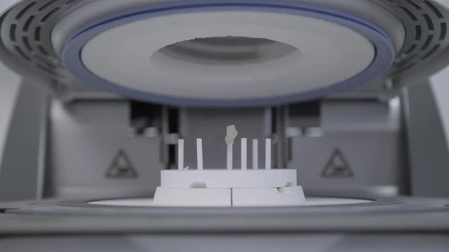 Artificial teeth in extremely high temperature oven in dental clinic. Dental technician bakes ceramic teeth in special furnace machine. Teeth reconstruction process in dental laboratory by technician
