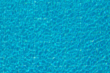 Wind waves on the pool. Background texture.