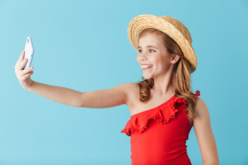 Cheerful little girl wearing swimsuit standing