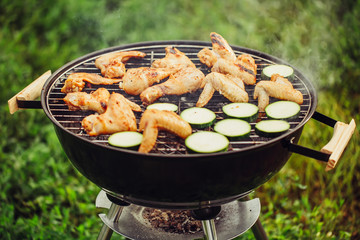 Chicken wings and zucchini on the grill