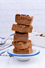 Chocolate cake with salt and caramel cookies on a white background. Traditional American dessert cut into portions. Free space for text. Copy space.