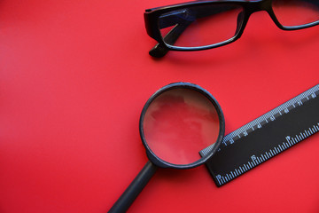 Stationery items close-up on a red background. View from above. Business concept. Flat lay:...