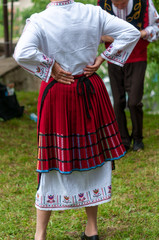 People in traditional costumes dance bulgarian