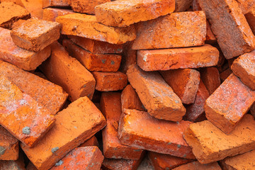 Pile of Red Clay Bricks on the Construction Work Site Floor