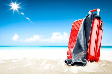 Summer suitcase on beach and travel time. Free space for your decoration and sunny day. 