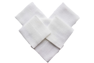 Square pad Gauzes in heart shape on isolated white background in care concept © vach