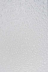 Silver liquid drops, many drops of abstract shapes on a silver b