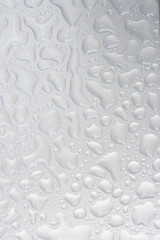 Silver liquid drops, many drops of abstract shapes on a silver b