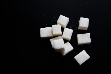 sugar cubes on black background