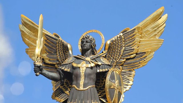 Golden statue of Archangel Michael and fountain spray at Independence Square in Kyiv, Ukraine